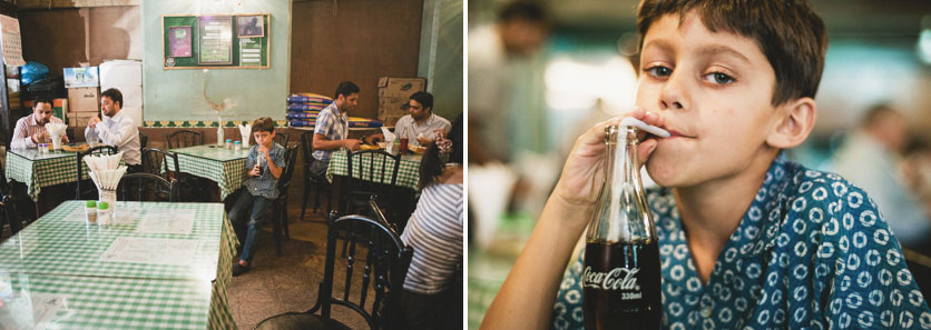 Boy drinking Coca Cola in Mumbai Cafe