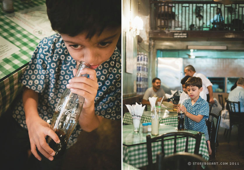 boy drinking thums up at Cafe Britannia