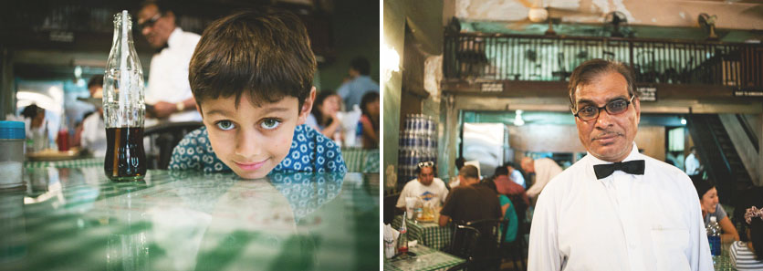Waiter at Cafe and boy sitting at table