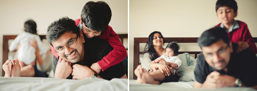 family hanging out on bed photo