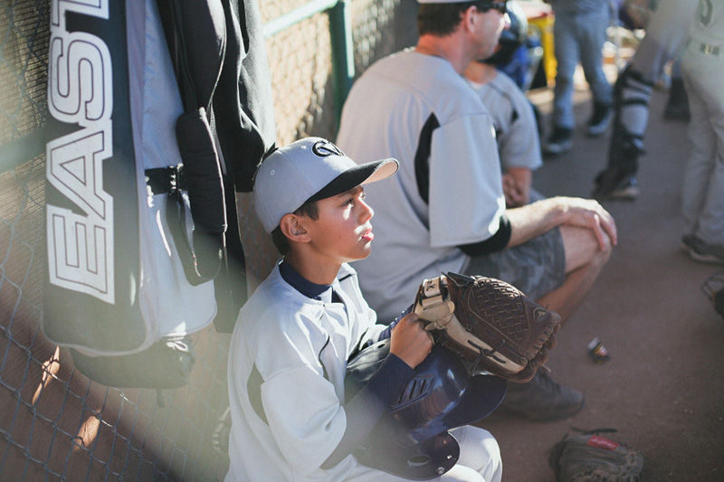 Baseball game with kid in dugout